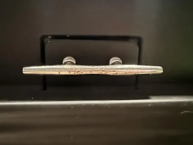 Slide: The Image of 2023 Manitou Explore 22 Max Bench boat cleat, close-up view. - 26