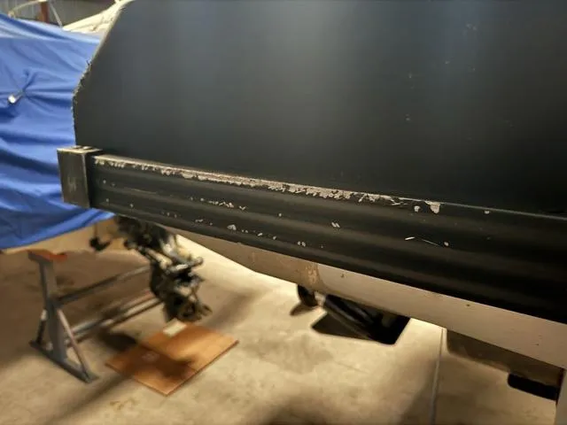 Slide: The Image of 2023 Manitou Explore 22 Max Bench boat detail in a garage setting. - 27