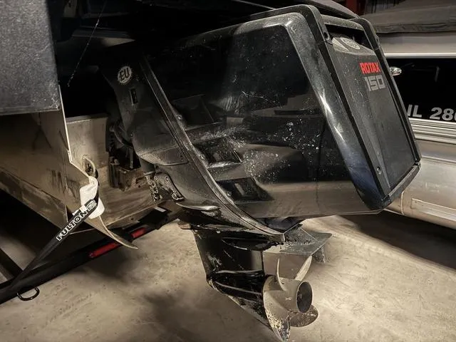 Slide: The Image of 2023 Manitou Explore 22 Max Bench boat with Rotax 150 engine, close-up view. - 30