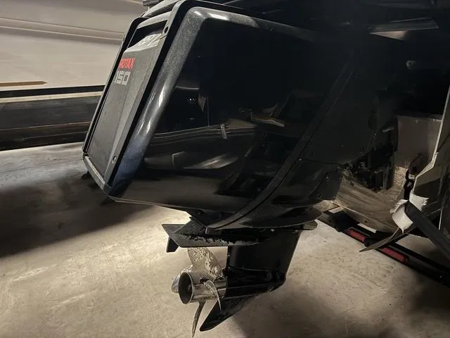 Slide: The Image of Outboard motor of a 2023 Manitou Explore 22 Max Bench boat. - 31