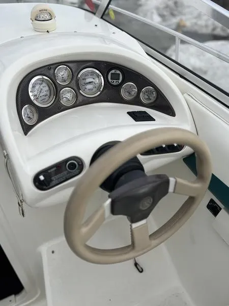 Slide: The Image of 2000 Glastron 249 boat dashboard with steering wheel and gauges. - 19