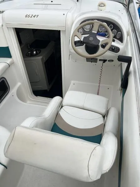 Slide: The Image of 2000 Glastron 249 boat interior with steering wheel and cabin entrance. - 3