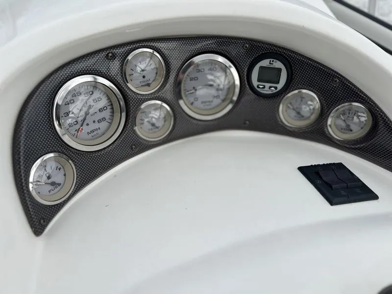 Slide: The Image of Dashboard of a 2000 Glastron 249 boat with various gauges and controls. - 5