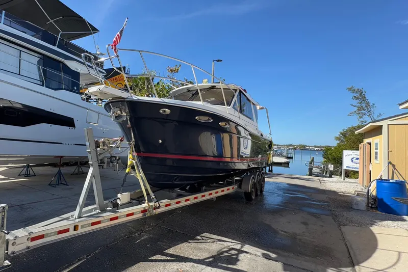 The Image of 2016 Cutwater C-28 boat on trailer at marina, sunny day. - 0