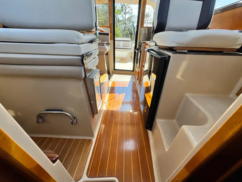 Slide: The Image of 2016 Cutwater C-28 interior with polished wood flooring and cushioned seating. - 10