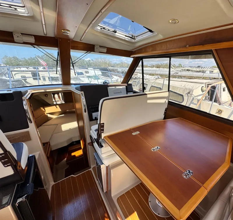 Slide: The Image of Interior of 2016 Cutwater C-28 boat with wooden table and seating area. - 4