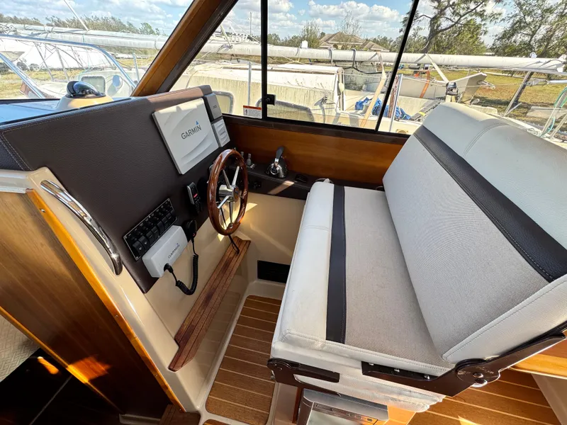 Slide: The Image of Interior of 2016 Cutwater C-28 boat with steering wheel and seating area. - 5