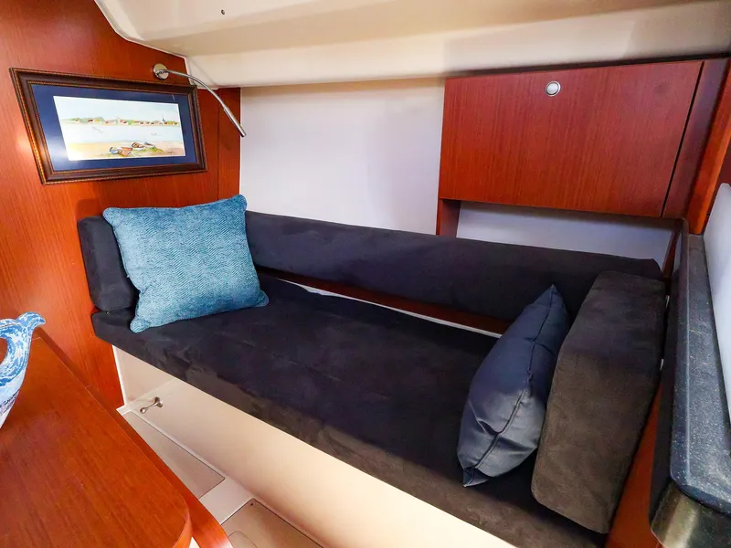 Slide: The Image of Cozy interior of 2018 Hanse 315 yacht with cushioned seating and decorative pillows. - 13