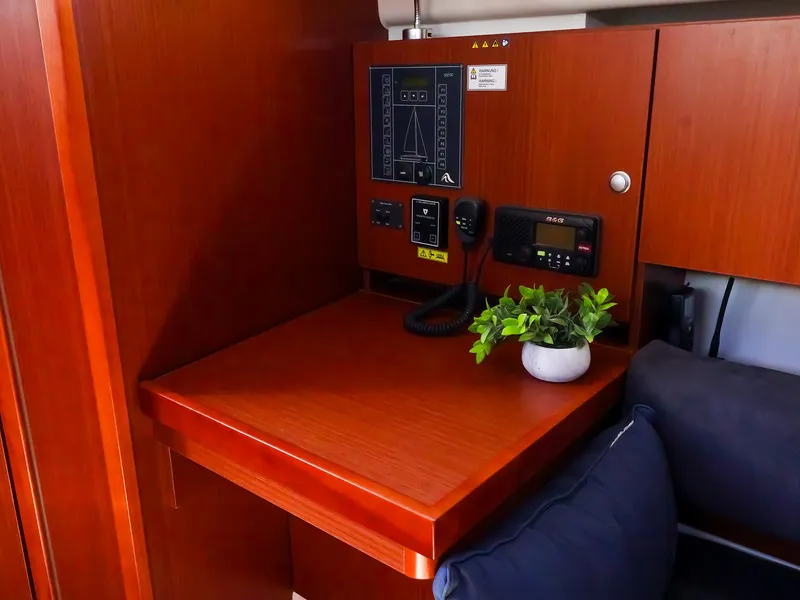 Slide: The Image of Navigation station in 2018 Hanse 315 yacht with control panel and potted plant. - 19