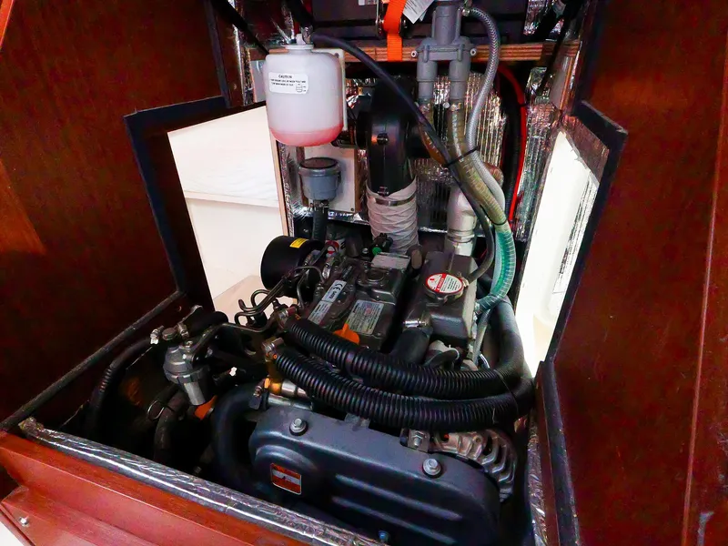 Slide: The Image of Engine compartment of a 2018 Hanse 315 sailboat, showcasing mechanical components and wiring. - 21