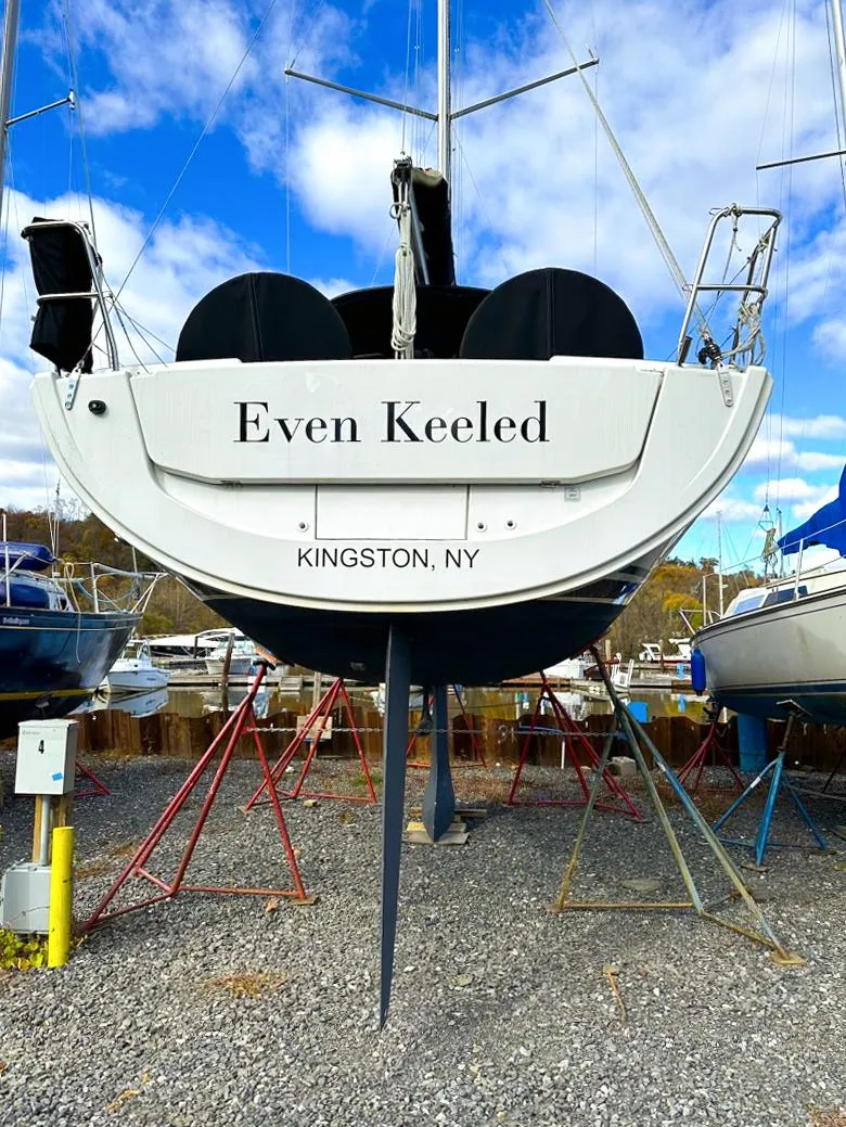 Slide: The Image of 2018 Hanse 315 sailboat named "Even Keeled" in Kingston, NY, on a boatyard stand. - 24