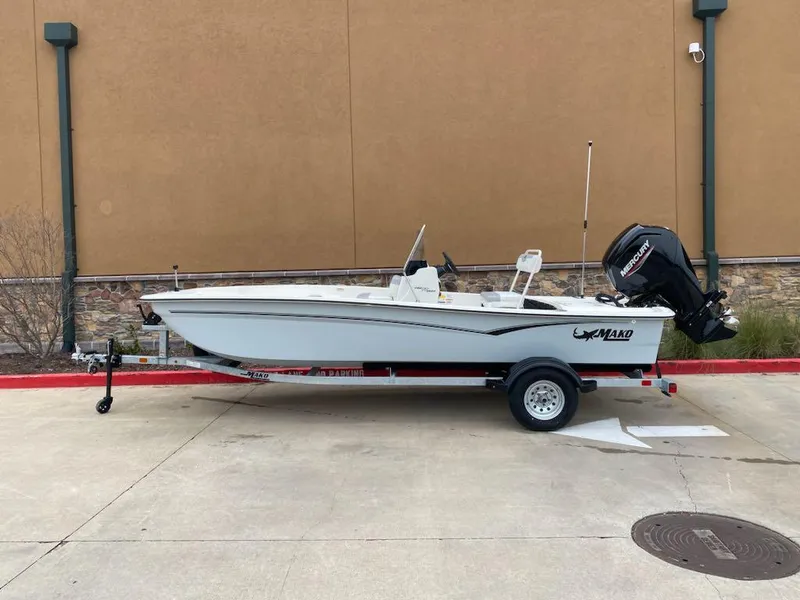Slide: The Image of 2025 Mako Pro Skiff 17 CC boat on trailer, parked outdoors. - 0