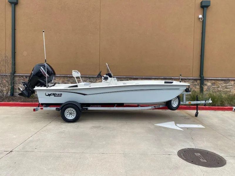 Slide: The Image of 2025 Mako Pro Skiff 17 CC boat on trailer, parked outdoors. - 1