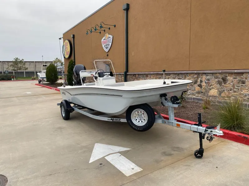 Slide: The Image of 2025 Mako Pro Skiff 17 CC boat on trailer, parked outdoors. - 2