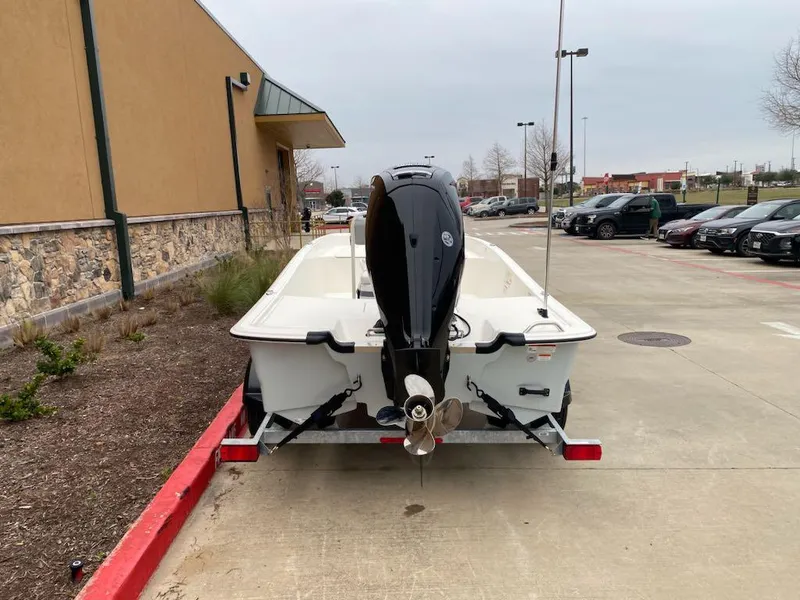 Slide: The Image of 2025 Mako Pro Skiff 17 CC boat on trailer in parking lot. - 3