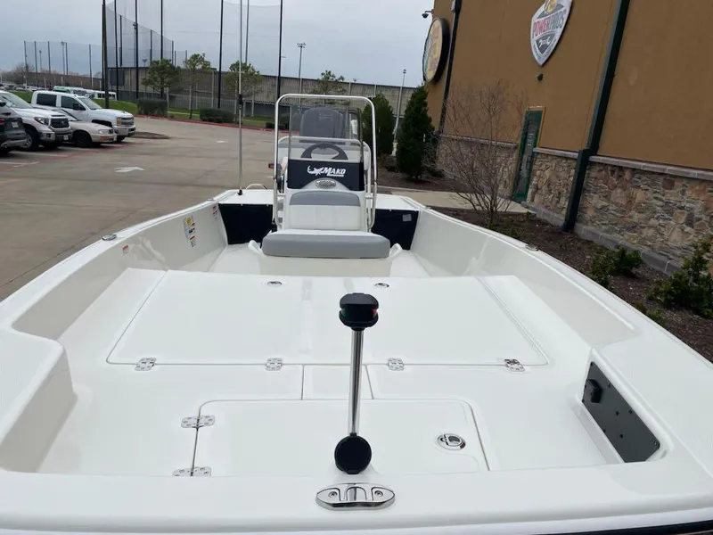 Slide: The Image of 2025 Mako Pro Skiff 17 CC boat in parking lot, showcasing spacious deck design. - 4