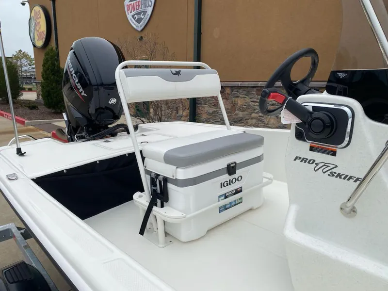 Slide: The Image of 2025 Mako Pro Skiff 17 CC boat with Igloo cooler and Mercury outboard motor. - 5