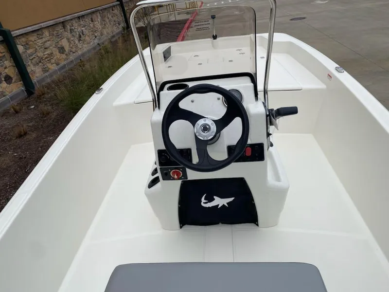 Slide: The Image of 2025 Mako Pro Skiff 17 CC boat interior with steering console and seating. - 6