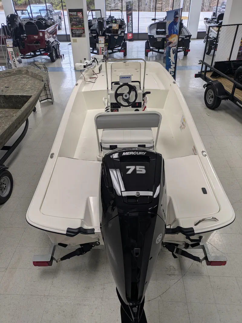 Slide: The Image of 2025 Mako Pro Skiff 17 CC boat with Mercury 75 engine in showroom. - 3