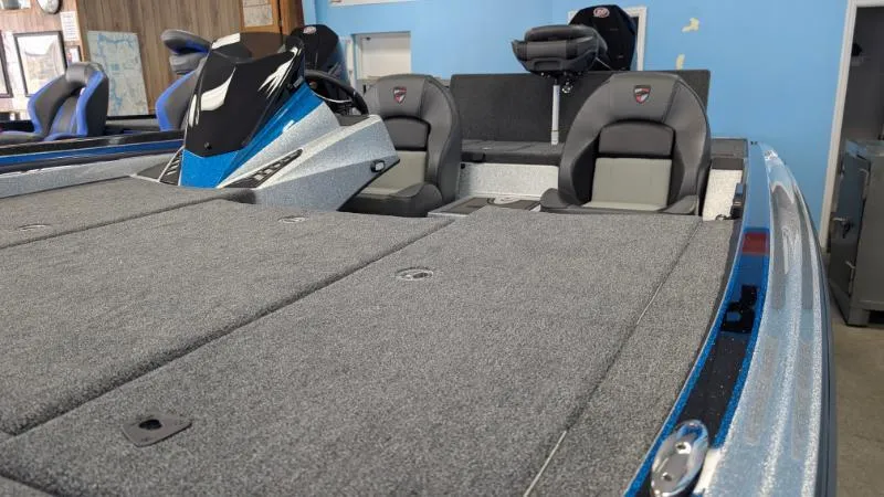 Slide: The Image of 2025 Triton 20XP Patriot boat interior with gray carpet and dual seating. - 10