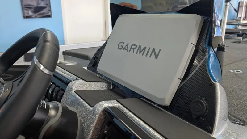 Slide: The Image of Garmin device on 2025 Triton 20XP Patriot boat dashboard, close-up view. - 2
