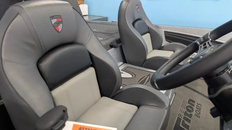 Slide: The Image of 2025 Triton 20XP Patriot boat interior with comfortable seating and steering wheel. - 5