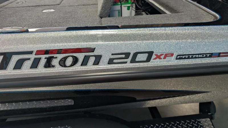 Slide: The Image of 2025 Triton 20XP Patriot boat, close-up of model name and logo. - 8
