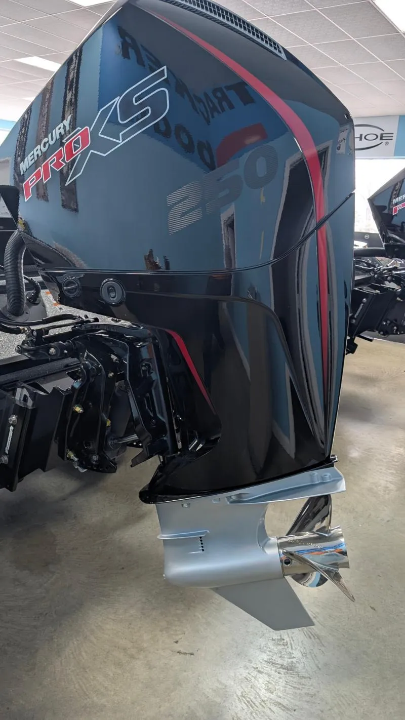 Slide: The Image of 2025 Triton 20XP Patriot with Mercury Pro XS outboard motor in showroom. - 9