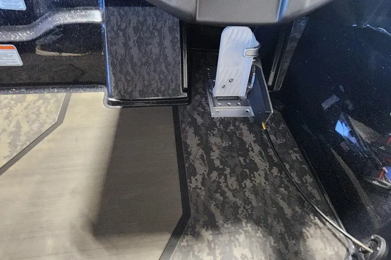 Slide: The Image of Foot pedal in 2025 Nitro Z20 XL boat with camo-patterned flooring. - 10