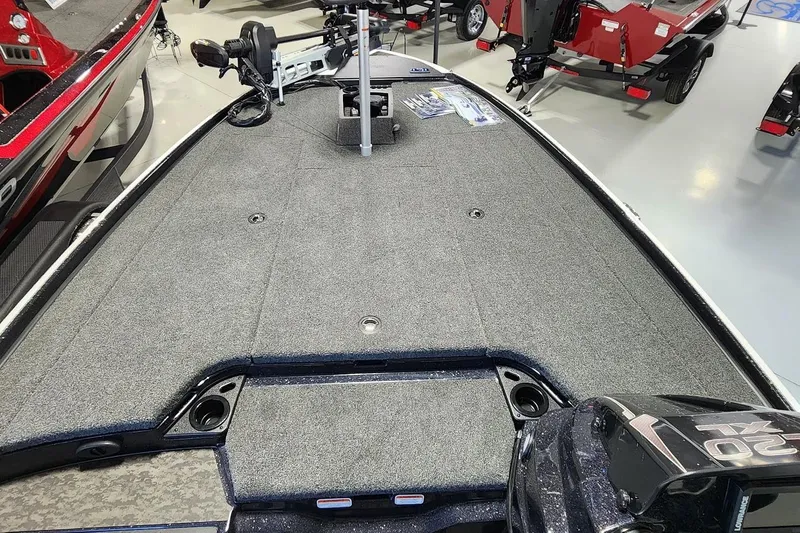 Slide: The Image of 2025 Nitro Z20 XL boat deck with carpeted surface and fishing equipment. - 5