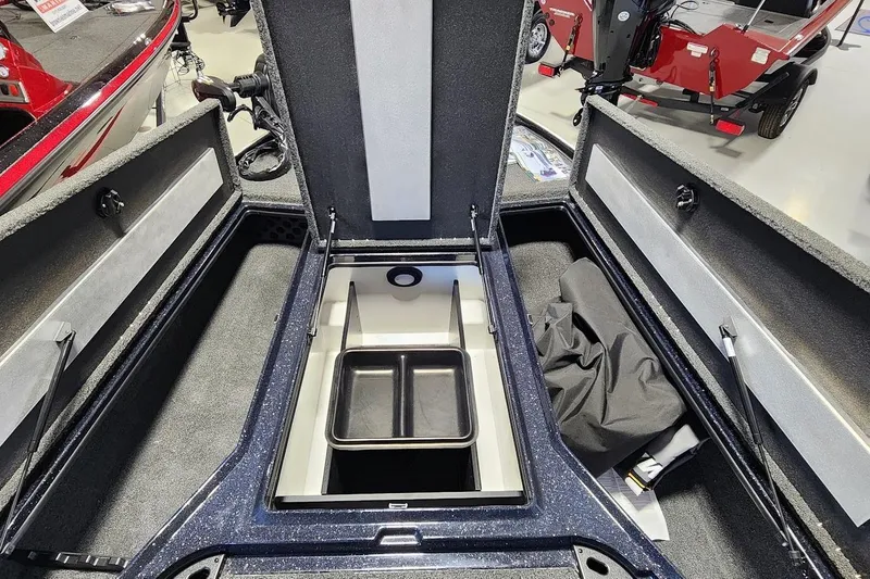 Slide: The Image of 2025 Nitro Z20 XL boat storage compartment with open lids and organized interior. - 7