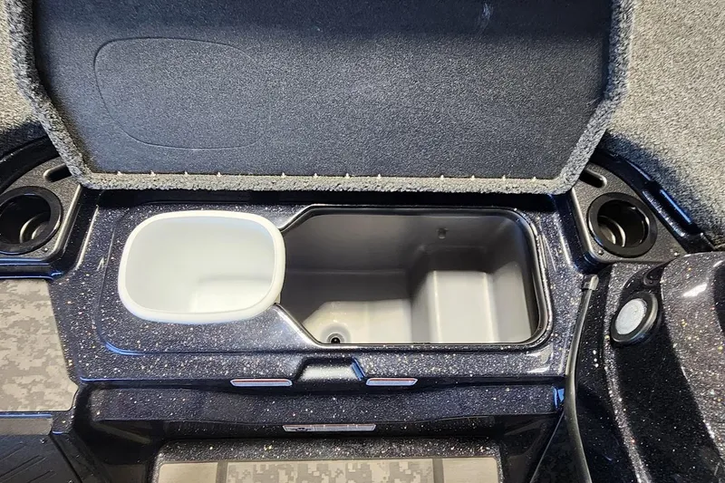 Slide: The Image of Open storage compartment in 2025 Nitro Z20 XL boat, featuring cup holders and sleek design. - 8