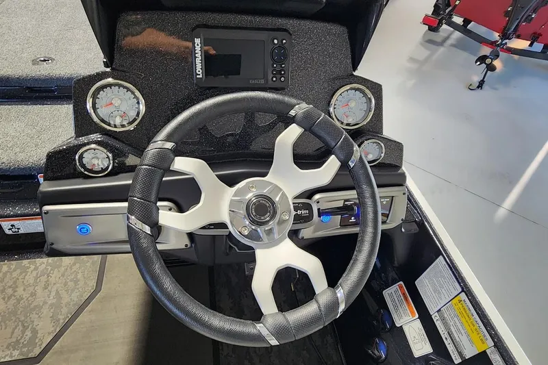 Slide: The Image of Steering wheel and dashboard of 2025 Nitro Z20 XL boat with gauges and controls. - 9