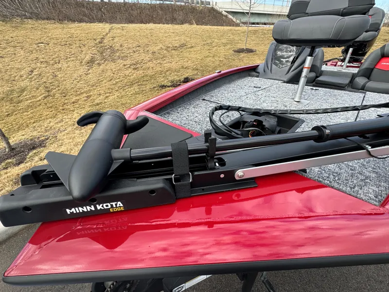 Slide: The Image of 2025 Tracker Pro Team 175 boat with Minn Kota Edge trolling motor on red deck. - 2