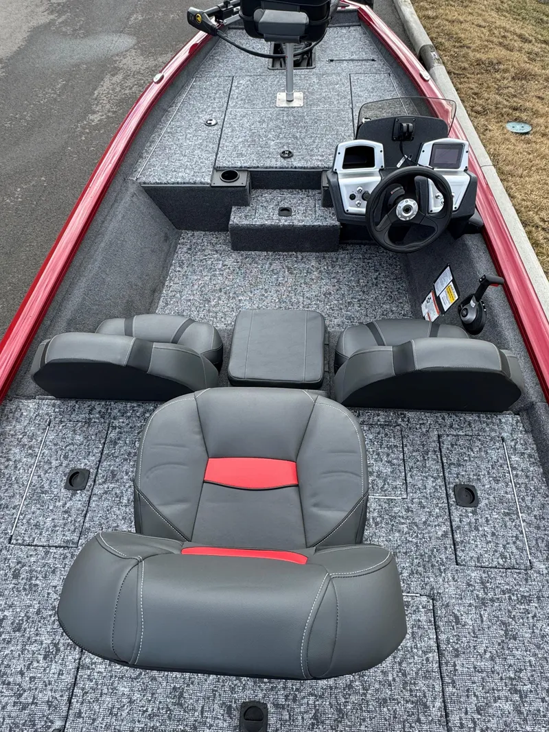 Slide: The Image of 2025 Tracker Pro Team 175 boat interior with gray and red seating, steering console, and storage compartments. - 3