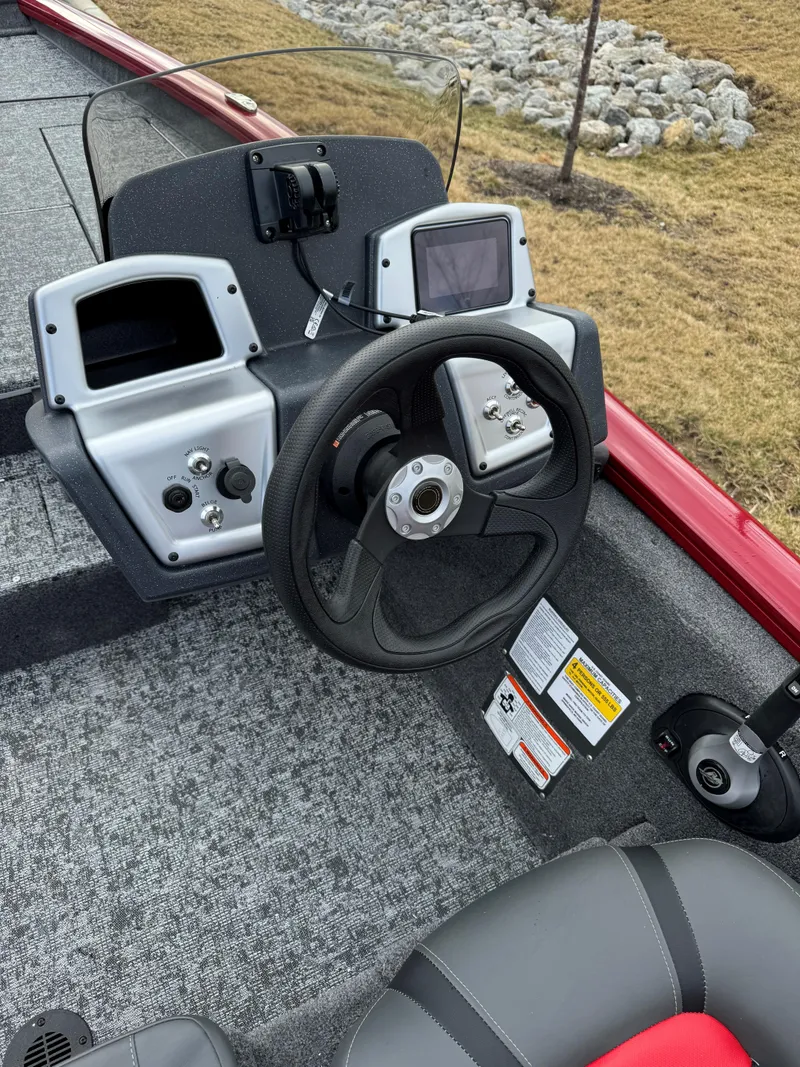 Slide: The Image of 2025 Tracker Pro Team 175 boat dashboard with steering wheel and electronic displays. - 5