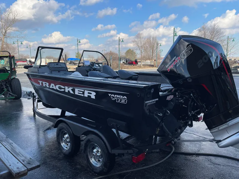 Slide: The Image of 2025 Tracker Targa V-18 WT boat on trailer, parked outdoors. - 2