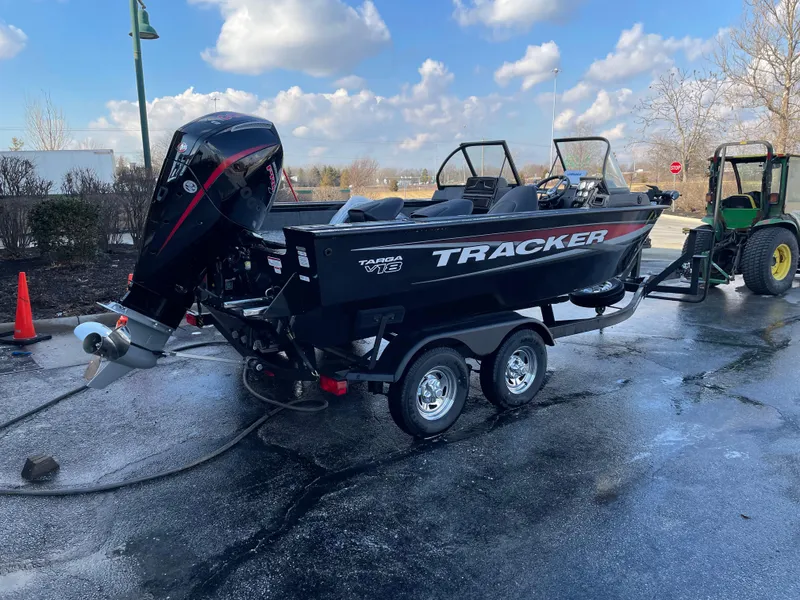 Slide: The Image of 2025 Tracker Targa V-18 WT boat on trailer, parked outdoors under a cloudy sky. - 3