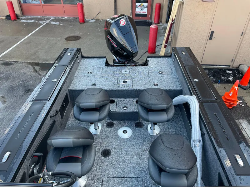 Slide: The Image of 2025 Tracker Targa V-18 WT boat interior with four seats and motor. - 5