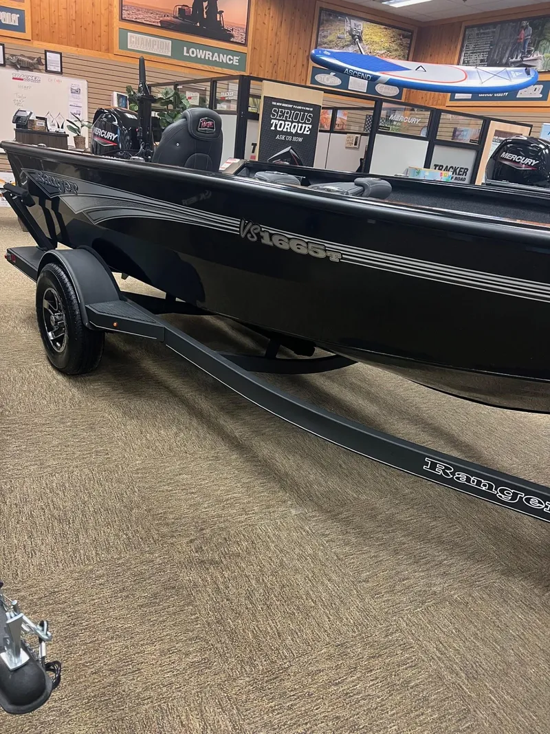 Slide: The Image of 2025 Ranger VS1665T boat on display in showroom with trailer. - 2
