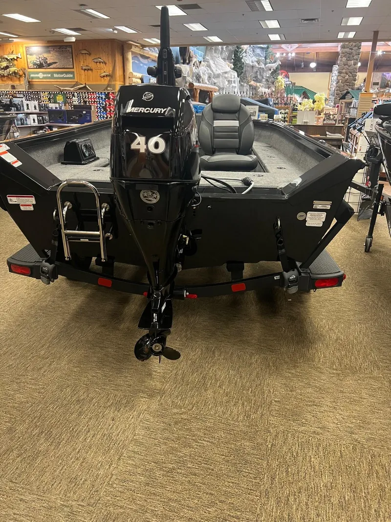 Slide: The Image of 2025 Ranger VS1665T boat with Mercury 40 engine displayed indoors. - 3