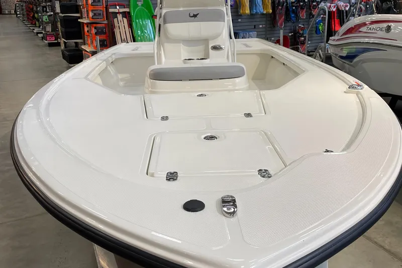 Slide: The Image of 2025 Mako 18 LTS boat, white deck, showroom display, front view. - 2