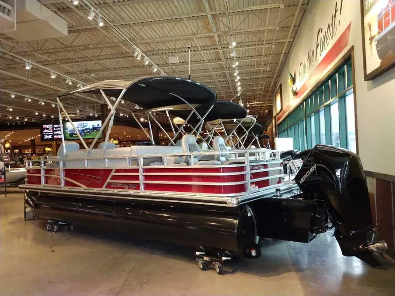 Slide: The Image of 2025 Ranger Reata 223F pontoon boat displayed indoors with sleek design and modern features. - 1