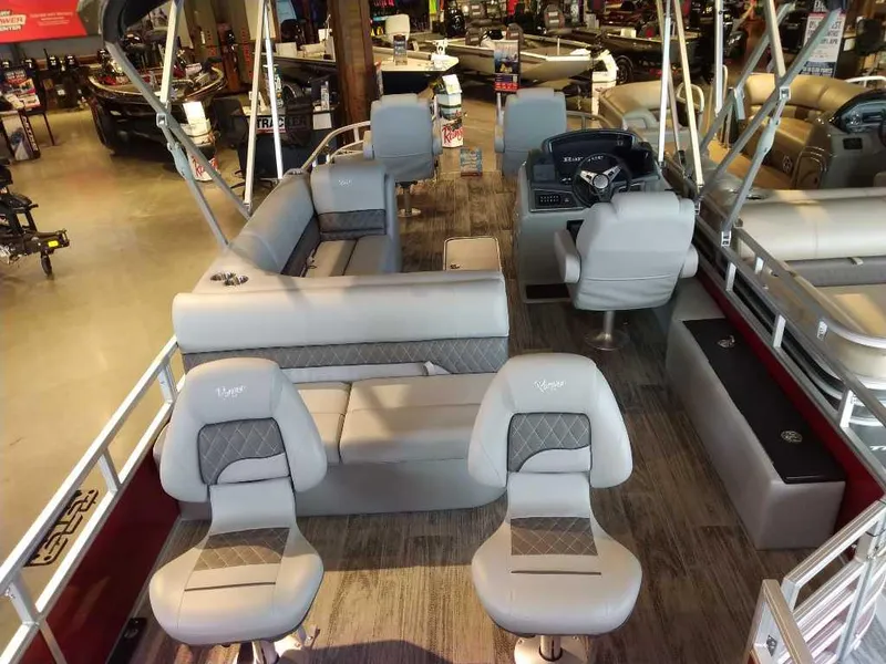 Slide: The Image of 2025 Ranger Reata 223F pontoon boat interior with plush seating and modern dashboard. - 7