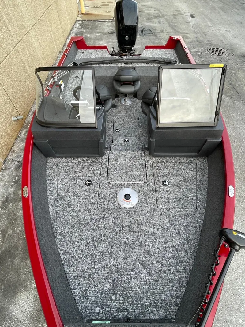 Slide: The Image of 2025 Tracker Pro Guide V-175 Combo boat with red exterior and spacious interior. - 2