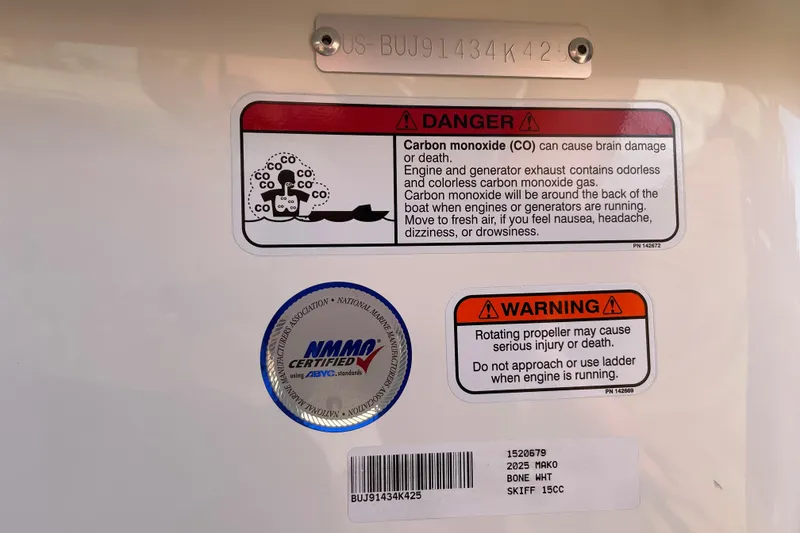 Slide: The Image of Warning labels on 2025 Mako Pro Skiff 15 CC boat, highlighting carbon monoxide and propeller dangers. - 62