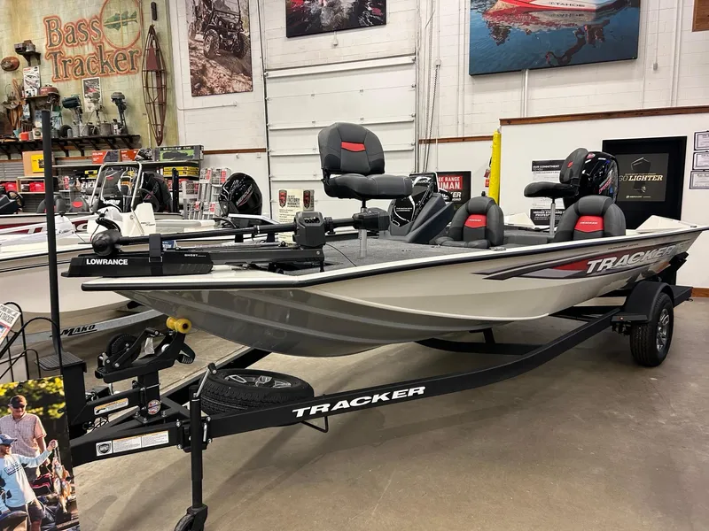 The Image of 2025 Tracker Pro Team 195 Tournament Edition boat displayed in showroom with fishing equipment. - 0