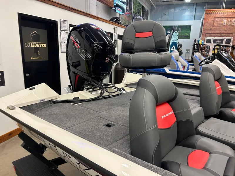 Slide: The Image of 2025 Tracker Pro Team 195 Tournament Edition boat with Mercury engine in showroom. - 3
