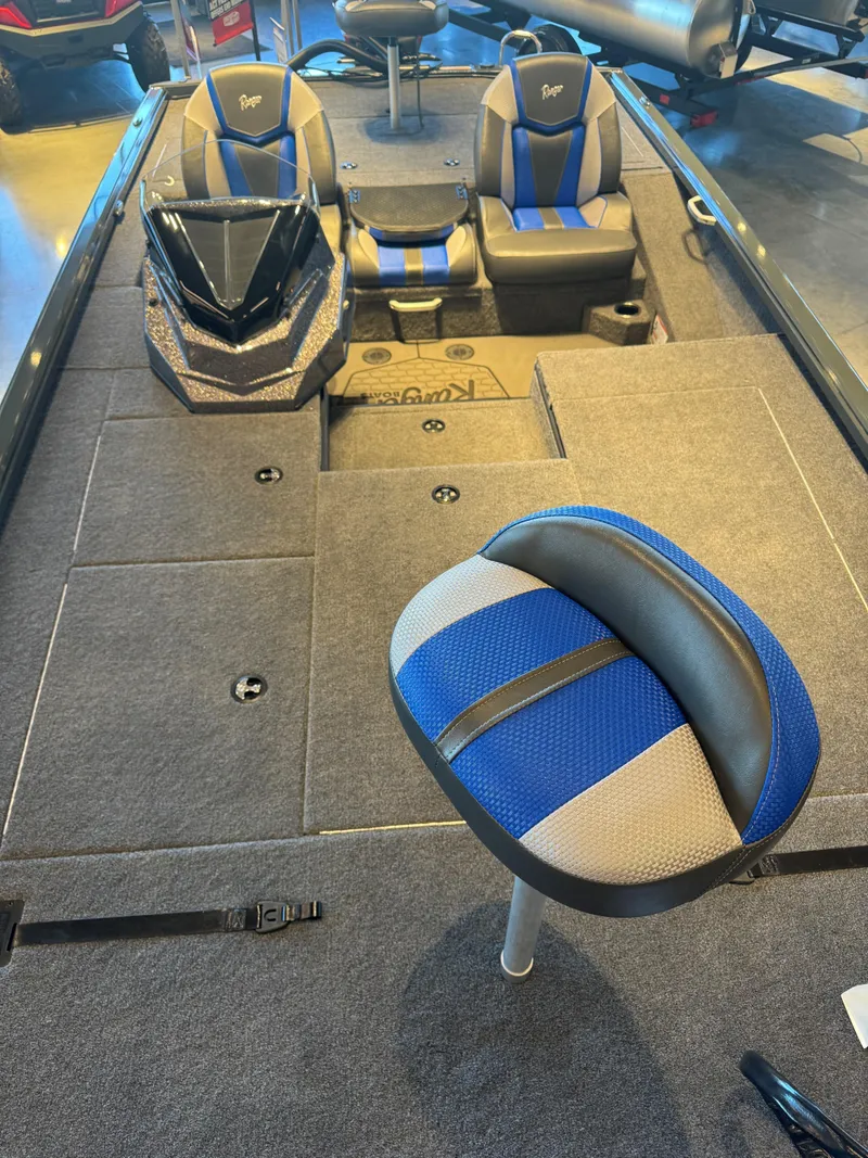Slide: The Image of 2025 Ranger ALPHA 208 boat interior with blue and gray seating and deck. - 3