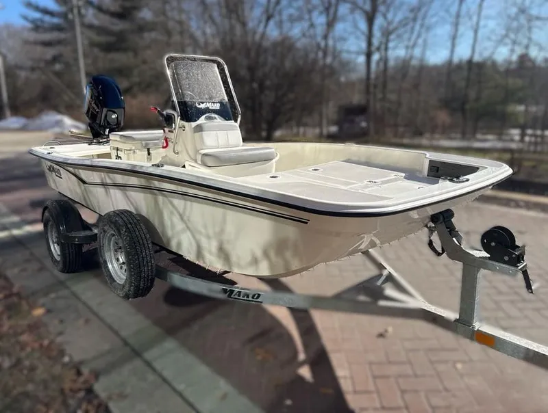 Slide: The Image of 2025 Mako Pro Skiff 15 CC boat on trailer, parked outdoors. - 2